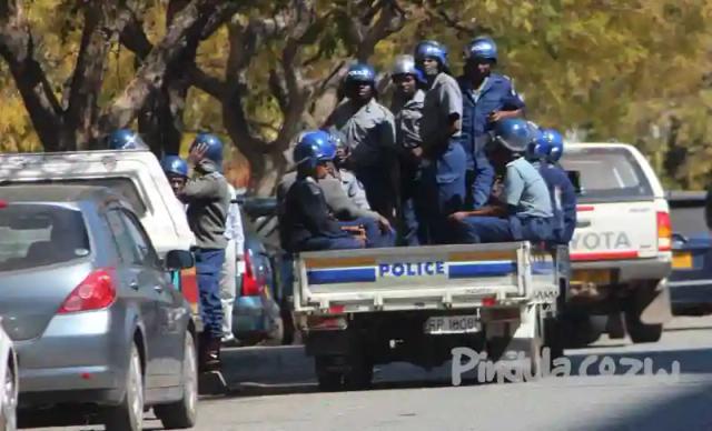 Journalists detained for recording armed riot police throwing out a white farmer to make way for Zanu-PF linked cleric