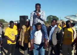Mugabe Party Candidate Addresses Rally On Bodyguard's Shoulders, Says ED Is Cruel