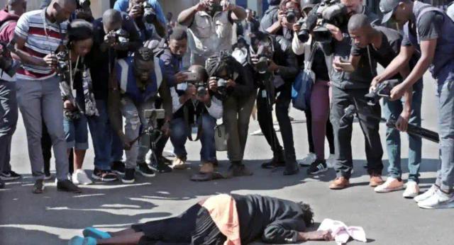 Photo: Woman Lies Unconscious While Journalists Focus On Taking Her Pictures